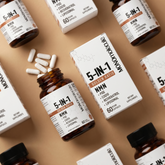 Supplement bottles and boxes labeled '5-IN-1' on a beige background