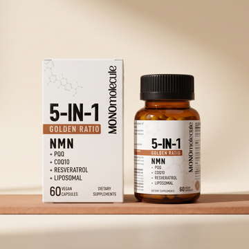 Monomolecule 5-In-1 Golden Ratio NMN dietary supplement, showing the white product box and amber glass bottle with a black cap, displayed on a wooden block against a warm beige background.